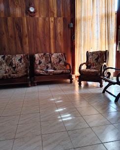 A sitting area with wooden walls and upholstered chairs